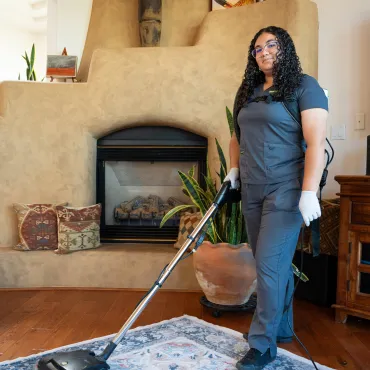 Merry Maids Corrales cleaner vacuuming inside a Corrales, New Mexico home — trusted local home cleaning service.